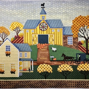 May include: A yellow and blue farmhouse with a red roof and a black rooster weathervane. The house is surrounded by trees with orange and yellow leaves. There is a small white sheep in the yard and a black horse-drawn carriage.