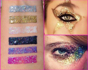 May include: Six different colors of glitter, including silver, gold, white, black, purple, and pink, are shown in swatches on a person's arm. The glitter is in a liquid form and is ready to be applied to the eyelids. The image also shows two examples of how the glitter can be used to create eye makeup looks.
