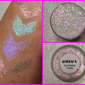 May include: A close-up of a jar of iridescent glitter labeled "OMEGA The Pretty Tribe". The glitter is a mix of white, pink, and blue.