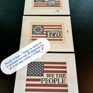 May include: Three needlepoint canvases featuring American flag designs. One canvas displays "250" and the Liberty Bell, another shows "1776", and the third reads "WE THE PEOPLE". The canvases have a cream background with red, white, and blue details.