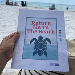 May include: A needlepoint canvas with the text "Return Me To The Beach" above a turtle graphic. The design features shades of blue and is set against a white background. The word "CHILL" is at the bottom.
