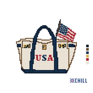 May include: A pixelated tote bag design with the word "USA" in red letters. The bag has a blue handle and trim, and a small American flag is attached. The design is on a white background.