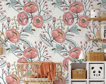 May include: A nursery room with a white floral wallpaper featuring pink flowers and green leaves. A wicker crib with a brown blanket is in the foreground. There are white shelves with wicker baskets and a white storage bin with a panda face on it.