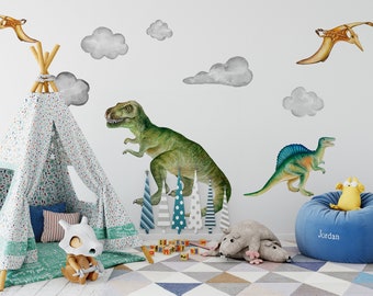 May include: A blue bean bag chair with the name "Jordan" embroidered on it. A yellow plush toy is sitting on the chair. The chair is in a room with a teepee tent, a dinosaur toy, and a gray plush rat.