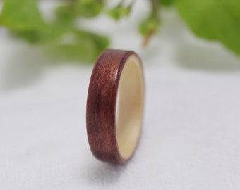 May include: A wooden ring with a dark brown outer band and a light brown inner band.