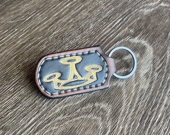 Dog eat dog double-sided leather keychain