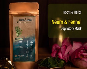 May include: A brown pouch with a label that reads "Roots & Herbs Neem & Fennel Depilatory Mask". The pouch contains a hair removal powder. The pouch is sitting on a wooden surface with a bowl of green leaves and a pink flower.