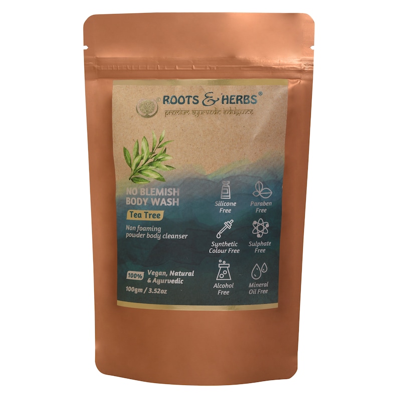 May include: A brown pouch with a label that reads "ROOTS & HERBS" and "NO BLEMISH BODY WASH Tea Tree". The label also lists ingredients and features, including "Vegan, Natural & Ayurvedic", "100gm / 3.52oz", and "Silicone Free, Paraben Free, Synthetic Colour Free, Sulphate Free, Alcohol Free, Mineral Oil Free".