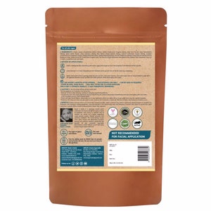May include: A brown paper bag with a product label. The label has a list of ingredients, instructions, and benefits. The product is not recommended for facial application. The label also includes a Halal certification, GMP certification, and a vegan symbol.