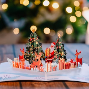 Pop Up Karte Weihnachten „Weihnachtsmann & Rentiere“ - 3D Weihnachtskarte für Frau, Freundinnen oder Kinder (Mädchen und Jungen)