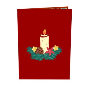 May include: A red card with a white candle with a yellow flame, a pine cone, and a red poinsettia flower surrounded by green leaves.
