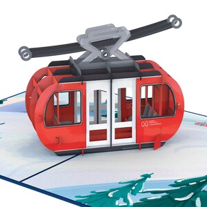 May include: A red and white cable car with a black cable and a gray support structure. The cable car is on a snowy mountain scene with green trees.
