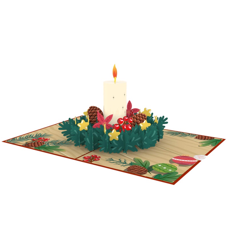 May include: A 3D pop-up card featuring a white candle surrounded by a green wreath with red berries, pine cones, and gold stars.
