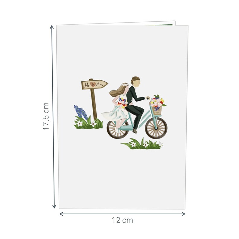 May include: A white card with a couple riding a blue bicycle with a basket of flowers. The sign above them reads "Mr. & Mrs.". The card measures 12 inches by 17.5 inches.