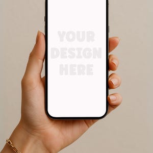 May include: A black smartphone with a blank white screen is held in a hand. The screen displays the text "YOUR DESIGN HERE" in a light grey font. A gold chain bracelet adorns the wrist. The background is a solid, neutral colour.