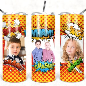 May include: Three stainless steel tumblers with a comic book theme. Each tumbler features a different comic book sound effect, such as "BOOM!" and "WHAM!" and a photo of a child. The tumblers are yellow with red polka dots.