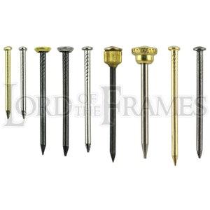 May include: Assortment of eight different types of picture hanging nails. The nails are made of metal and have different finishes, including brass, silver, and black. Some of the nails have decorative heads.