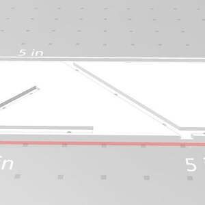 May include: A white, rectangular, 12.7 cm by 12.7 cm piece of material with two diagonal cuts.