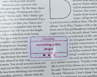 May include: A rectangular sticker with a pink border and the words "remember everything will be alright" in a handwritten style. The sticker has three small heart shapes at the bottom.