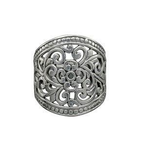 May include: Silver ring with a filigree design featuring a central flower motif.