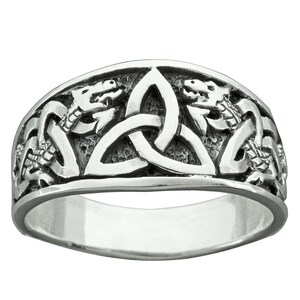 May include: A silver ring with a Celtic knot design and two dragons on either side.