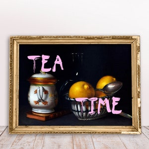 May include: A framed still life painting with a black background. The painting features a white and gold ceramic jar with a lid, a silver spoon, three lemons, and a glass bottle. The words "TEA TIME" are written in pink across the bottom of the painting.
