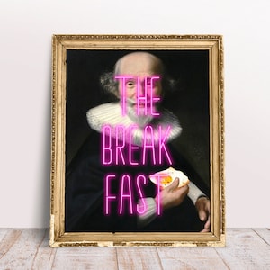 May include: A framed portrait of a man with a white beard and collar, holding a fried egg. The words "THE BREAKFAST" are written in pink neon letters across the image.