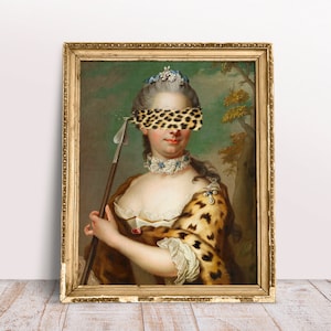 May include: A vintage oil painting of a woman in a gold frame. The woman is wearing a white dress and a leopard print shawl. Her eyes are covered with a leopard print patch. She is holding a spear in her right hand.