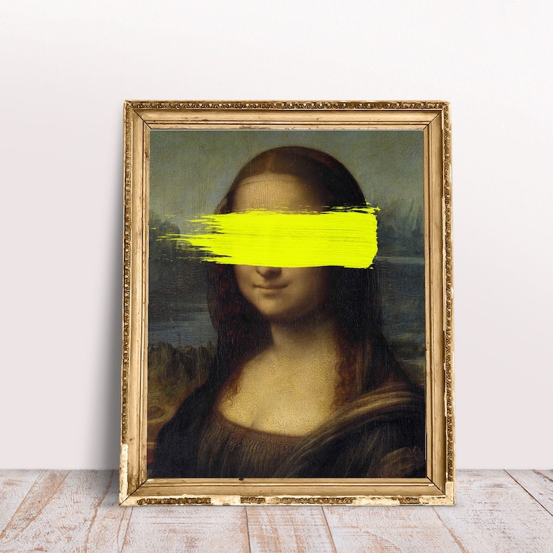 May include: A framed painting of the Mona Lisa with a bright yellow brushstroke covering her eyes.
