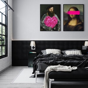 May include: Two framed black and white art prints hanging on a white wall above a black headboard. The print on the left features a man in a suit holding a pink heart-shaped bouquet of flowers. The print on the right features a woman with a pink stripe over her eyes.
