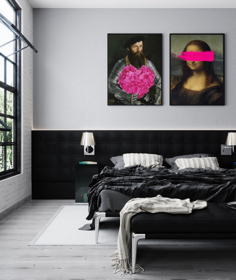 May include: Two framed black and white art prints hanging on a white wall above a black headboard. The print on the left features a man in a suit holding a pink heart-shaped bouquet of flowers. The print on the right features a woman with a pink stripe over her eyes.