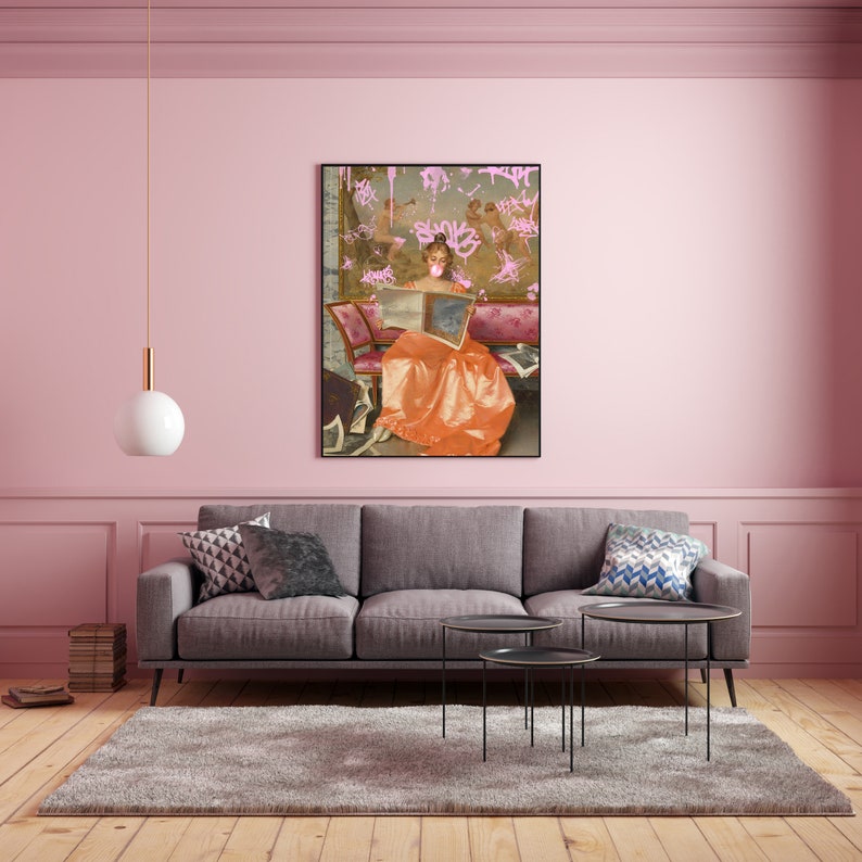 May include: A painting of a woman in a long orange dress sitting on a couch and reading a book. The painting is surrounded by pink graffiti.