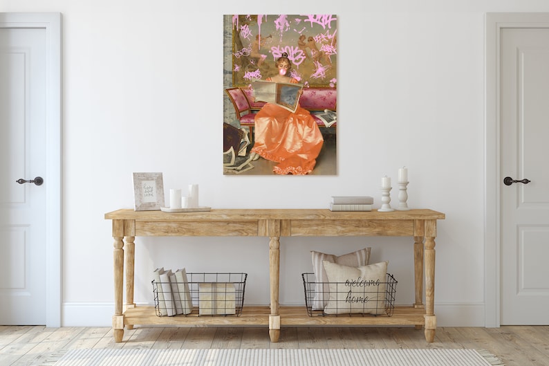 May include: A painting of a woman in a long orange dress sitting on a couch and reading a book. The background is a pink and white wall with pink graffiti.