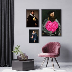 May include: Three framed portraits of people in historical clothing. The portraits are hung on a gray wall. The portrait on the left shows a man with a beard wearing a dark blue jacket and holding a yellow object. The portrait in the middle shows a woman with a white collar wearing a dark blue dress and holding a pink object. The portrait on the right shows a man with a beard wearing a dark blue jacket and holding a large pink flower.