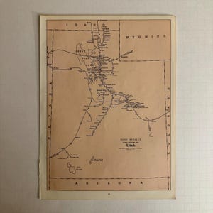 May include: A vintage map of Utah, featuring a network of railway lines and geographical details. The map, printed on aged paper, includes the text "Rand McNally" and "Utah" with state borders and place names.