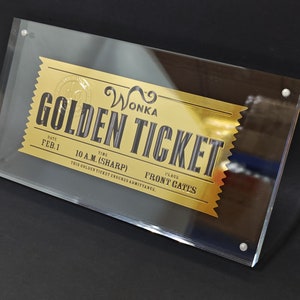 May include: A gold-coloured ticket with black text that reads "WONKA GOLDEN TICKET". The ticket has a date of "FEB. 1" and a time of "10 A.M. (SHARP)". The ticket also has a place of "FRONT GATES".