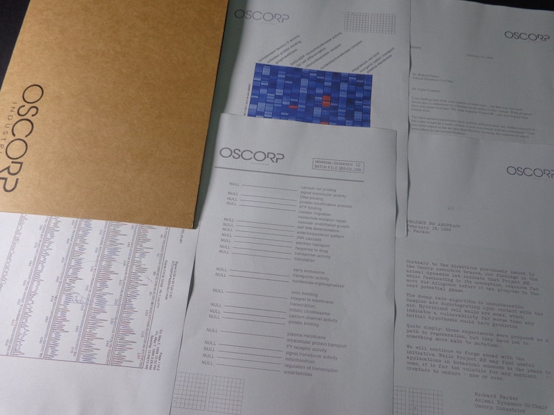 May include: A black and white document with the text "OSCORP INDUSTRIES" at the top. The document contains a table with data and a graph with blue and red squares.