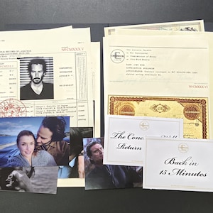 May include: A collection of printed documents and photographs featuring a criminal record with a portrait of a man, a Continental document with the name John Wick, a gold-colored certificate, and two white cards with the text The Continental Return and Back in 15 Minutes.