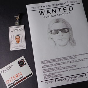 May include: A black and white wanted poster with a sketch of a man with long hair and sunglasses. The poster states "WANTED FOR QUESTIONING" and includes a description of the suspect and the crime. The poster also includes the contact information for the New York Police Department.