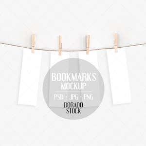 May include: Four white bookmarks hanging on a clothesline with wooden pegs. The bookmarks are blank and ready for personalisation. The text on the image reads "BOOKMARKS MOCKUP PSD + JPG + PNG DORADO STOCK".