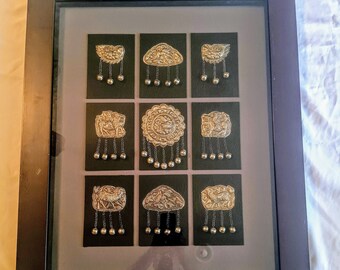 Vintage, 9 Chinese handmade Miao silver jewelry pieces displayed in a frame