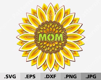 Puede incluir: Un diseño de papel recortado en capas de un girasol con la palabra "MOM" en el centro. El girasol es amarillo, naranja y marrón. La palabra "MOM" es verde.