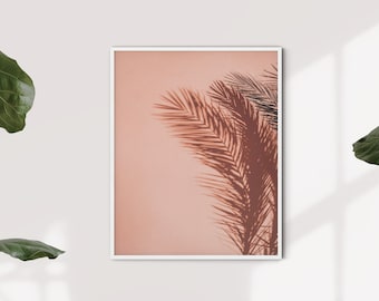 May include: A framed print of a palm tree shadow against a peach-colored background.