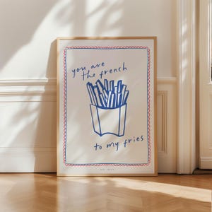May include: A white poster with a blue and red border. The poster has a blue illustration of french fries in a box and the text "you are the french to my fries".