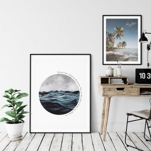 May include: A framed print with a watercolor illustration of a blue ocean with waves. The text "You are not a drop in the ocean. You are the entire ocean, in a drop" is written in a circle around the ocean.