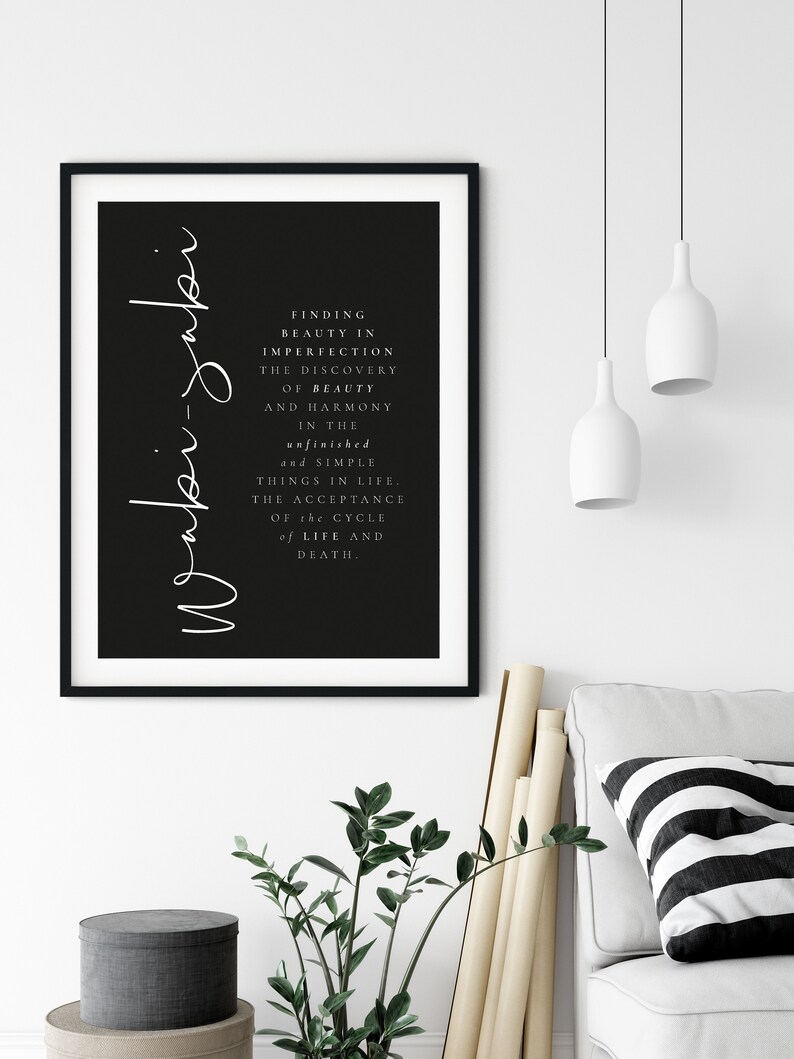 May include: Black and white print with the text "Finding beauty in imperfection. The discovery of beauty and harmony in the unfinished and simple things in life. The acceptance of the cycle of life and death." The text is written in a cursive font and is centered on the page. The background is black.