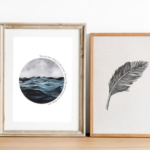 May include: Two framed prints, one with a watercolor painting of a stormy sea in a circle with the text "You are not a ship in the ocean, but the ocean itself", and the other with a black and white illustration of a feather.