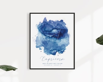 May include: A framed wall art print featuring a blue watercolor splash with a white constellation overlay. The text reads Capricorn, Won't be happy until you are, and December 22 - January 19. The design is centered on a white background.