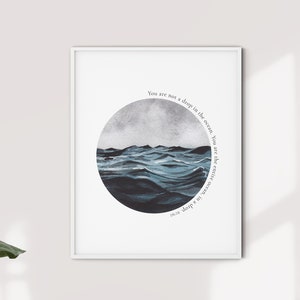 May include: A framed print with a watercolor illustration of a stormy ocean in a circle. The text "You are not a drop in the ocean. You are the entire ocean in a drop" is written around the circle.