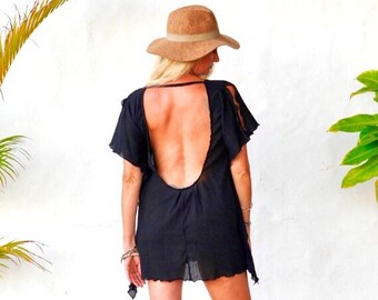 May include: A black, sheer, open-back dress with ruffled sleeves. The dress is worn by a person wearing a brown hat.